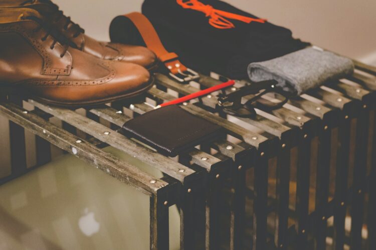 pair of brown leather dress shoes beside black leather wallet