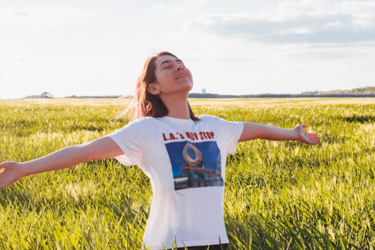 woman standing in green field